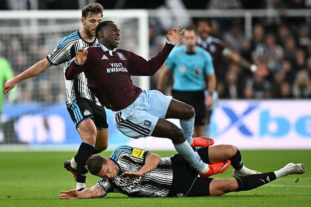 Newcastle United's Dutch defender #04 Sven Botman (down) fouls Aston Villa's Senegalese striker #11 Nicolas Jackson (up) during the English Premier League football match between Newcastle United and Aston Villa at St James' Park in Newcastle-upon-Tyne, north east England on October 17, 2026. (Photo by Paul ELLIS / AFP via Getty Images)