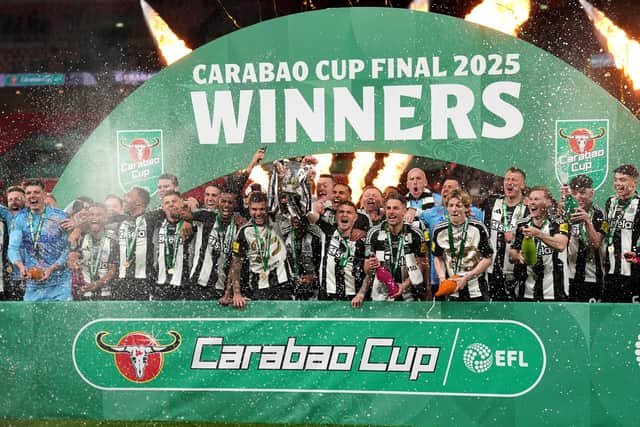 Newcastle United's Bruno Guimaraes and Kieran Trippier lift the Carabao Cup trophy with team-mates following victory at Wembley Stadium over Liverpool. (Photo by Owen Humphreys/PA Wire)
