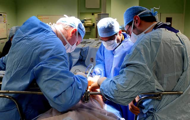 EMBARGOED TO 0001 MONDAY FEBRUARY 4 File photo dated 7/4/11 of an operation taking place. An extra 290,000 operations could be carried out on the NHS every year if the way theatre lists are managed was improved, a national review has found.