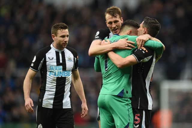 Newcastle United's Welsh defender Paul Dummett (L), Newcastle United's English defender Dan Burn (2nd L), Newcastle United's Slovakian goalkeeper Martin Dubravka (2nd R) and Newcastle United's Swiss defender Fabian Schar (R) celebrate on the pitch after the English Premier League football match between Newcastle United and Aston Villa at St James' Park in Newcastle-upon-Tyne, north east England on February 13, 2022.