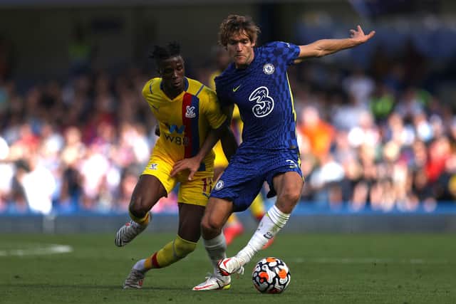 Marcos Alonso of Chelsea is challenged by Wilfried Zaha of Crystal Palace during the Premier League match between Chelsea and Crystal Palace at Stamford Bridge on August 14, 2021 in London, England. (Photo by Eddie Keogh/Getty Images)
