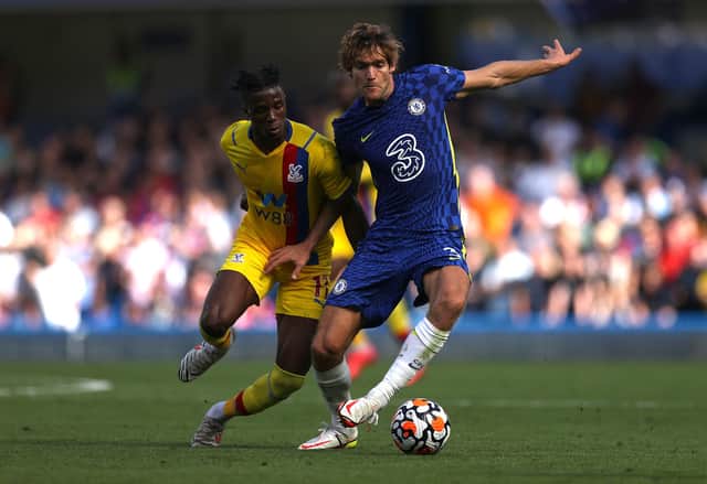 Marcos Alonso of Chelsea is challenged by Wilfried Zaha of Crystal Palace during the Premier League match between Chelsea  and  Crystal Palace at Stamford Bridge on August 14, 2021 in London, England. (Photo by Eddie Keogh/Getty Images)