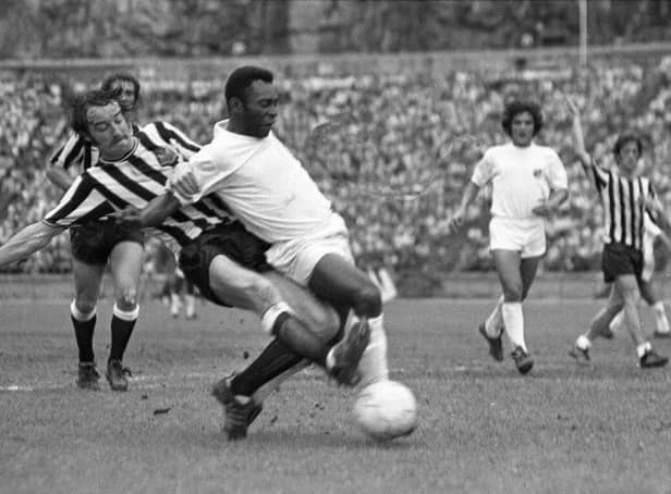 Newcastle United defender Frank Clark tackles Pele during the challenge match in Hong Kong. Pic courtesy of Paul Joannou/NUFC archive.