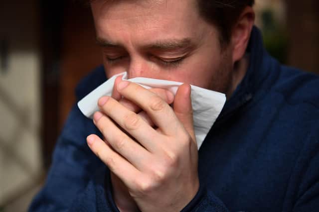  PICTURE POSED BY MODEL
A man sneezes into a tissue. PA Photo. Picture date: Saturday March 14, 2020. Photo credit should read: Ben Birchall/PA Wire 