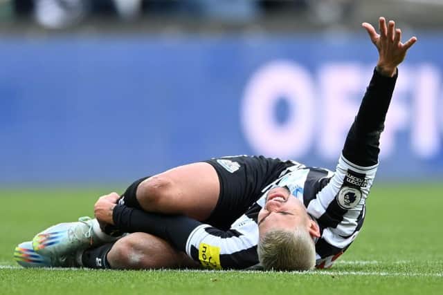 Bruno Guimaraes of Newcastle United goes down with an injury during the Premier League match between Newcastle United and Fulham FC at St. James Park on January 15, 2023 in Newcastle upon Tyne, England. (Photo by Michael Regan/Getty Images)