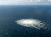 This handout picture released on September 27, 2022 by the Danish Defence Command shows the gas leak at the Nord Stream 2 gas pipeline as it is seen from the Danish Defence's F-16 rejection response off the Danish Baltic island of Bornholm, south of Dueodde. - The two Nord Stream gas pipelines linking Russia and Europe have been hit by unexplained leaks.