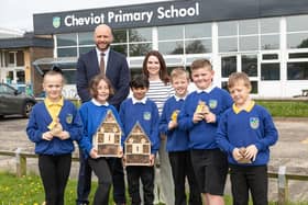 Bellway Sales Manager Chris Lawson, teacher Ashleigh Waite with students at Cheviot Primary