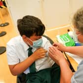 Felix Dima, 13, from Newcastle receives the Pfizer-BioNTech COVID-19 vaccine at the Excelsior Academy on September 22, 2021 in Newcastle upon Tyne, England.  Photo by Ian Forsyth/Getty Images