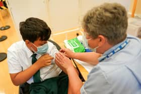 Felix Dima, 13, from Newcastle receives the Pfizer-BioNTech COVID-19 vaccine at the Excelsior Academy on September 22, 2021 in Newcastle upon Tyne, England.  Photo by Ian Forsyth/Getty Images