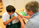 Felix Dima, 13, from Newcastle receives the Pfizer-BioNTech COVID-19 vaccine at the Excelsior Academy on September 22, 2021 in Newcastle upon Tyne, England.  Photo by Ian Forsyth/Getty Images