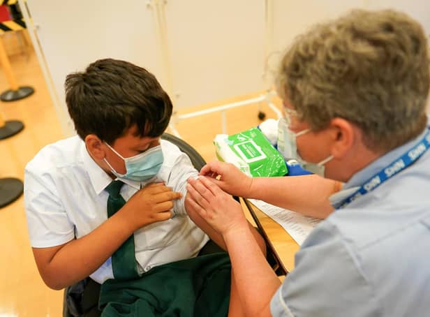 <p>Felix Dima, 13, from Newcastle receives the Pfizer-BioNTech COVID-19 vaccine at the Excelsior Academy on September 22, 2021 in Newcastle upon Tyne, England.  Photo by Ian Forsyth/Getty Images</p>