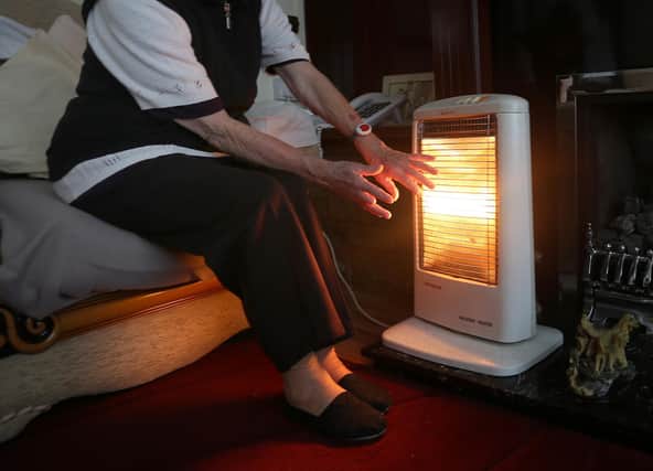 A generic stock photo of an elderly lady with her electric fire on at home in Liverpool.