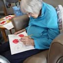 Resident from HC-One’s Falstone Manor Care Home creating poppies for the city’s upcoming VE Day celebrations