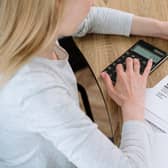Busy woman working at home office calculating and paying utility bills for house rent.