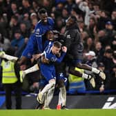 Chelsea players mob hat-trick hero Cole Palmer during the 4-3 win over Man Utd.