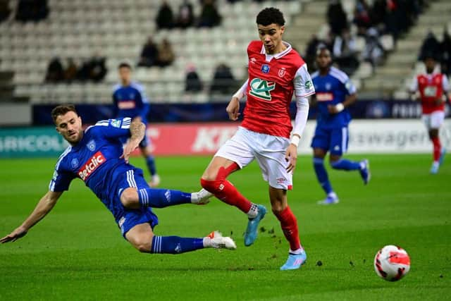 Reims' French forward forward Hugo Ekitike (R) fights for the ball with Bastia's French defender Joris Sainati during the French Cup round of 16 football match between Reims and Bastia at the Auguste Delaune Stadium in Reims on January 29, 2022 (Photo by DENIS CHARLET/AFP via Getty Images)