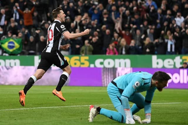 Chris Wood of Newcastle United celebrates after scoring their side's first goal as Jose Sa of Wolverhampton Wanderers looks dejected during the Premier League match between Newcastle United and Wolverhampton Wanderers at St. James Park on April 08, 2022 in Newcastle upon Tyne, England. (Photo by Stu Forster/Getty Images)