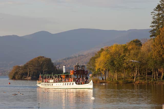 Windermere Lake Cruises' vessel MV Tern glides past the stunning autumn landscapes of the Lake District