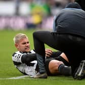 Newcastle United midfielder Bruno Guimaraes receives medical treatment against Fulham.