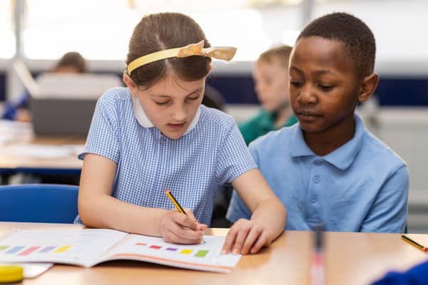 School children learning with White Rose Education workbooks..