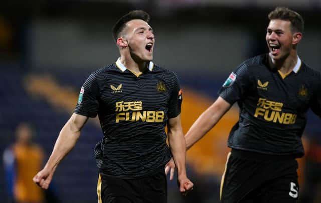 Dylan Stephenson (L)  celebrates with his teammate Cameron Ferguson of Newcastle United after scoring his team's first goal during the Papa John's EFL Trophy Group match between Mansfield  Town and Newcastle United U21 (Photo by Laurence Griffiths/Getty Images)