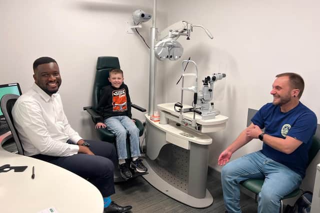 Specsavers optometrist Williams Okezie, Frankie Crow and Liam Crow