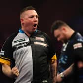 Chris Dobey celebrates after winning his third round match against Josh Rock (right) during day eleven of the Paddy Power World Darts Championship at Alexandra Palace, London