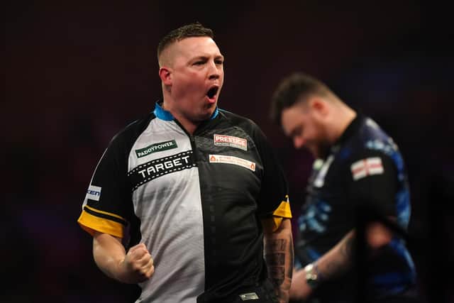 Chris Dobey celebrates after winning his third round match against Josh Rock (right) during day eleven of the Paddy Power World Darts Championship at Alexandra Palace, London