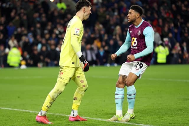 James Trafford of Burnley celebrates with teammate Josh Laurent after saving a penalty from Wilson Isidor of Sunderland.