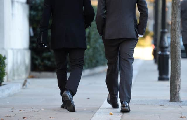 File photo dated 29/11/16 of men walking near St Paul's Cathedral, London, as a study has found that single men feel under more pressure to be in a relationship than women.