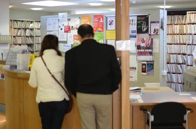 Patients wait at reception at the Temple Fortune Health Centre GP Practice near Golders Green, London.