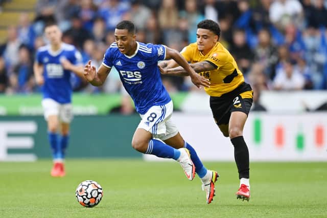 LEICESTER, ENGLAND - AUGUST 14: Youri Tielemans of Leicester is fouled by Ki-Jana Hoever of Wolves during the Premier League match between Leicester City  and  Wolverhampton Wanderers at The King Power Stadium on August 14, 2021 in Leicester, England. (Photo by Michael Regan/Getty Images)