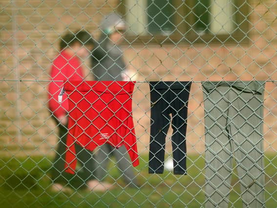 A view of people thought to be migrants at the Manston immigration short-term holding facility located at the former Defence Fire Training and Development Centre in Thanet, Kent. 700 people were moved to the Manston facility for safety reasons after incendiary devices were thrown at a Border Force migrant centre in Dover on Sunday. Picture date: Monday October 31, 2022.