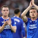 Rangers duo Leon King and Steven Davis applaud their supporters after their 4-0 defeat to Ajax in Amsterdam. (Photo by KENZO TRIBOUILLARD/AFP via Getty Images)