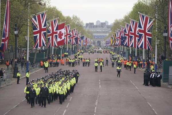 Metropolitan Police officers march along The Mall in London as they head to their positions for of the coronation processions of King Charles III and Queen Camilla.