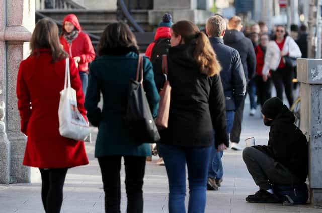 A homeless man begging on the streets of Dublin.