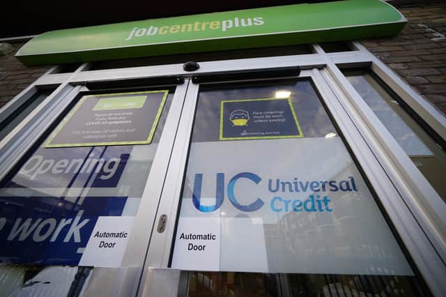 A Universal Credit sign on a door of a job centre plus in east London. Recipients of Universal Credit (UC) have described feeling "pushed beyond limits" due to the impact of cuts. A £20-per-week uplift to the benefit that was introduced at the start of the coronavirus pandemic ended on Wednesday, leaving recipients of UC £1,040 worse off per year. Picture date: Wednesday October 6, 2021.