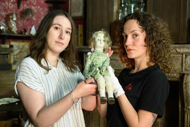 Competition winner, Skye Burchell, and London Dungeon archivist, Scarlett Litster, holding Skye's porcelain doll Florence which was deemed Britain's most cursed object and features in the London Dungeon's Cabinet of Curiosities show