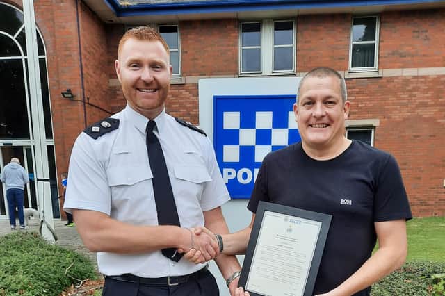 Daniel Wadcock with his commendation from Ch Supt Mark Hall.