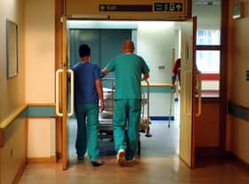 Orderlies push a bed at the Royal Orthopaedic Hospital, Oswestry.