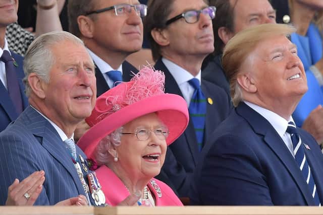 (L-R) Britain's Prince Charles, Prince of Wales, Britain's Queen Elizabeth II and US President Donald Trump look up as aircraft perform a fly-over during an event to commemorate the 75th anniversary of the D-Day landings, in Portsmouth, southern England, on June 5, 2019. - US President Donald Trump, Queen Elizabeth II and 300 veterans are to gather on the south coast of England on Wednesday for a poignant ceremony marking the 75th anniversary of D-Day. Other world leaders will join them in Portsmouth for Britain's national event to commemorate the Allied invasion of the Normandy beaches in France -- one of the turning points of World War II. (Photo by Daniel LEAL-OLIVAS / AFP) (Photo credit should read DANIEL LEAL-OLIVAS/AFP/Getty Images)