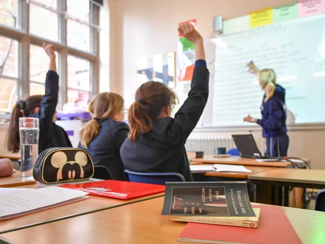 File photo dated 12/09/18 of a teacher and students in a classroom. Poorer pupils are less likely to get into top-performing comprehensive schools than their peers even if there is one in their local area, a study by charity group Sutton Trust has found. Issue date: Thursday January 11, 2024.