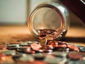 Coins falling out of jar