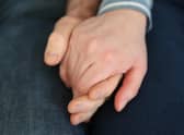 File photo dated 05/02/20 of a married couple holding hands, as couples could receive financial support from their partners if relationships break down, a report aimed at reforming the law for cohabiters in Scotland has suggested.