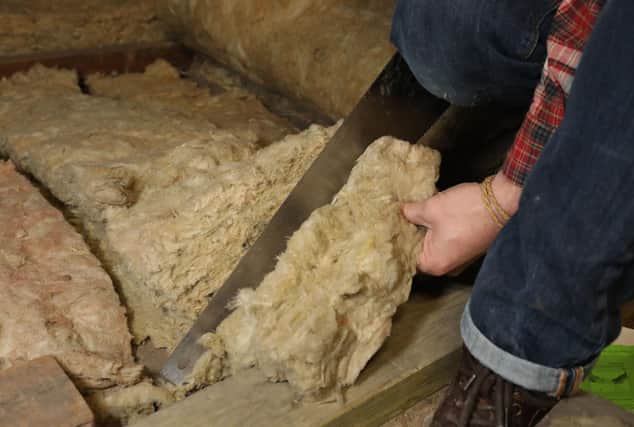 File photo dated 14/11/17 of a person laying loft insulation. Barclays has extended its scheme to pay up to £2,000 to mortgage holders to help make their homes green as new research shows more than half of homeowners do not feel confident making their properties more energy efficient. Issue date: Thursday July 6, 2023.