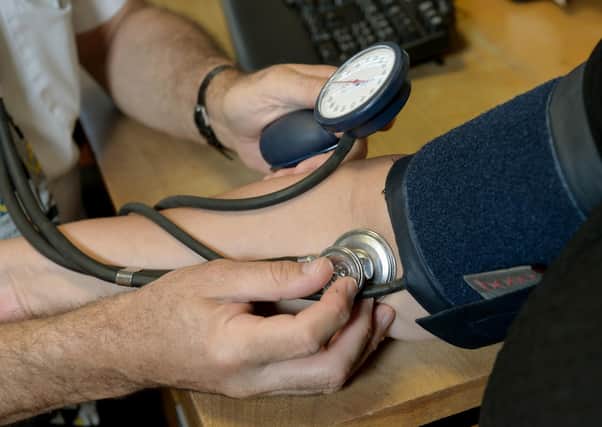 File photo dated 10/09/14 of a doctor checking a patient's blood pressure in their practice room at the Temple Fortune Health Centre GP Practice near Golders Green, London. The number of four-week waits for GP appointments in England is rising, new figures suggest. Around 1.3 million appointments in May were booked more than four weeks previously, new data released by the Liberal Democrats shows. Issue date: Tuesday July 18, 2023.