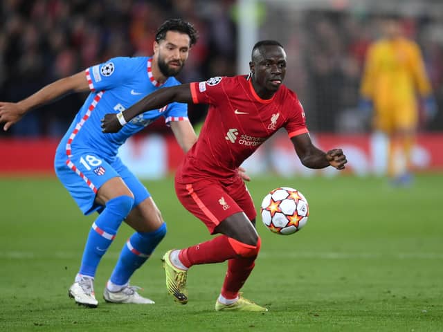LIVERPOOL, ENGLAND - NOVEMBER 03: Sadio Mane of Liverpool holds the ball whilst under pressure from Felipe of Atletico Madrid during the UEFA Champions League group B match between Liverpool FC and Atletico Madrid at Anfield on November 03, 2021 in Liverpool, England. (Photo by Laurence Griffiths/Getty Images)