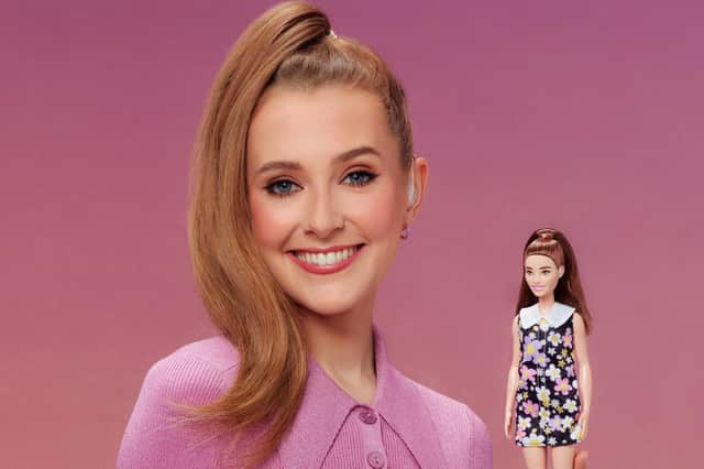 Rose Ayling-Ellis poses with the first ever Barbie doll with a behind-the-ear hearing aid