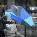 People brave the rain and wind. (Pic credit: Christopher Furlong / Getty Images)