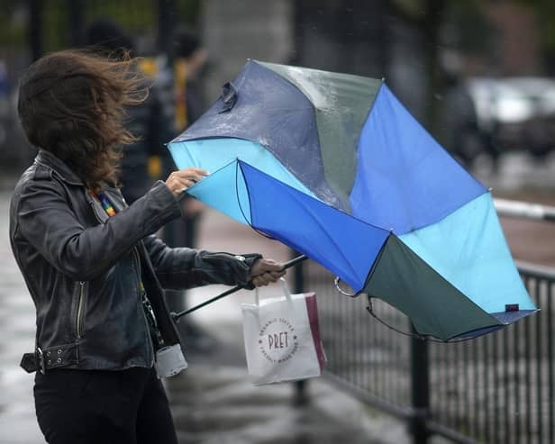 People brave the rain and wind. (Pic credit: Christopher Furlong / Getty Images)